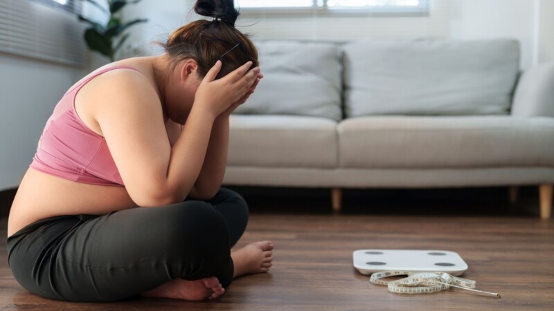 person frustrated while restarting a short term fitness program after missing workouts